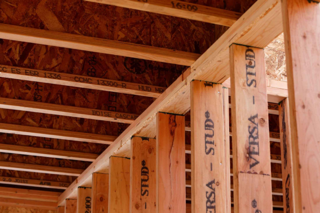 Wooden beams and joists in the interior structure of a building under construction.