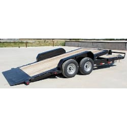 black flatbed trailer with dual axles and wooden deck on a concrete surface