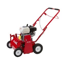 Red lawn aerator with four wheels and a black engine, designed for efficient soil aeration and lawn maintenance.