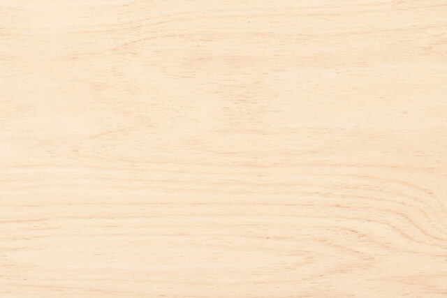 Light wood texture background with subtle grain patterns.