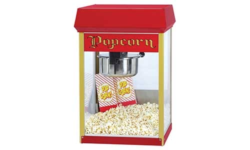 Red popcorn machine filled with popped corn and two popcorn bags, featuring a retro design with the word "Popcorn" at the top.