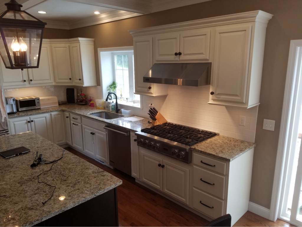 This image depicts a kitchen showcasing white partial overlay cabinet doors for a classic look.