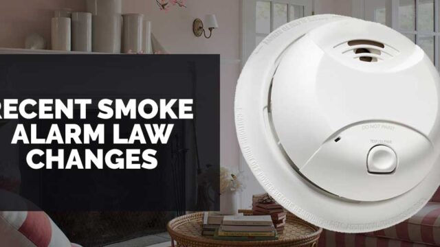 Smoke alarm mounted on a ceiling with text indicating updates on smoke alarm law changes.