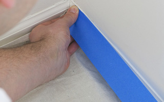 Masking off the baseboard with painters tape