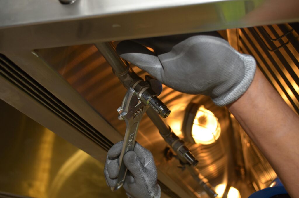 This image depicts a person adjusting a gas line.