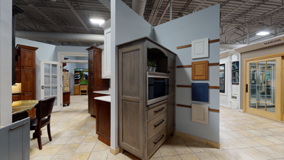 showroom with wooden cabinets and a built-in microwave next to wall decor in a brightly lit interior