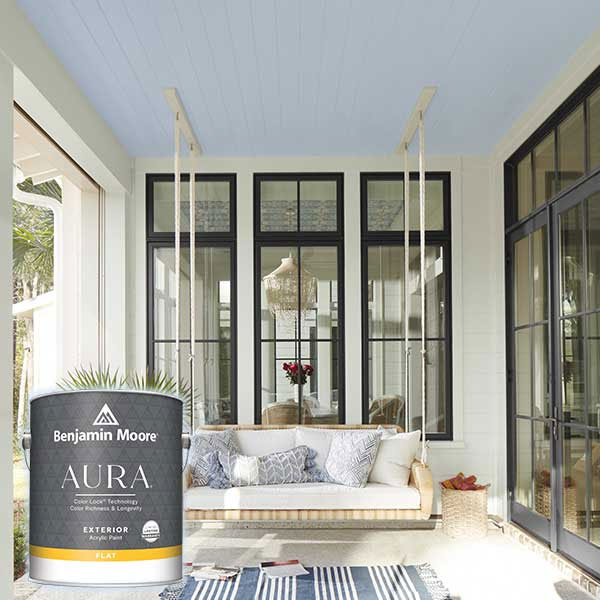 Blue painted ceiling veranda with modern seating and a can of Benjamin Moore AURA paint in the foreground.