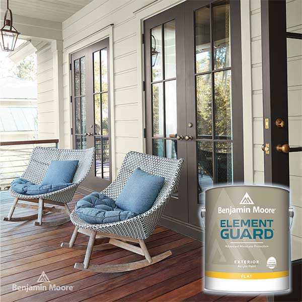 Covered porch with wicker chairs and blue cushions, near a can of Element Guard paint on wooden flooring.