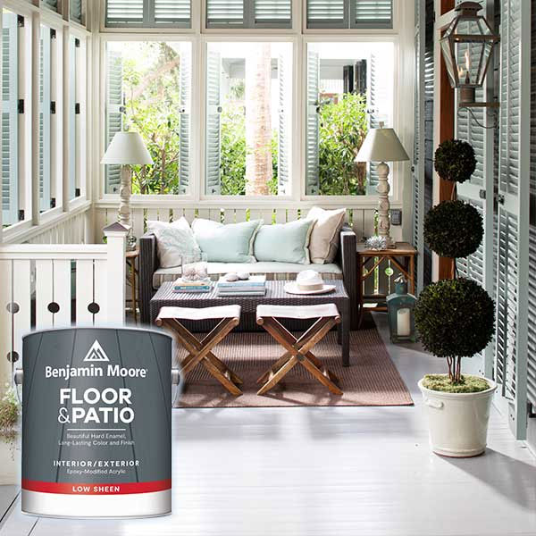 sunlit patio with cozy seating and a can of floor and patio paint in the foreground