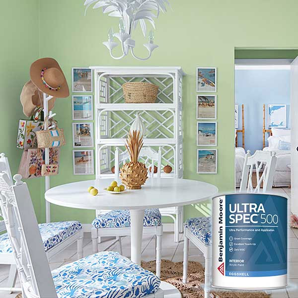 Dining room with white furniture, green walls, decorative items, and a can of Ultra Spec 500 paint in the foreground.